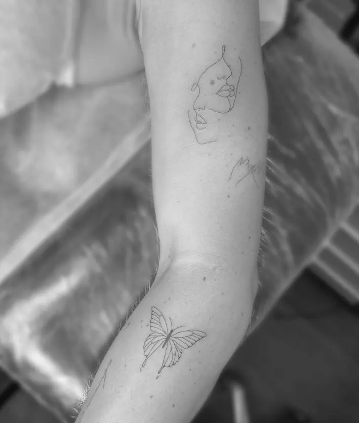 Single line face profile with butterfly tattoo by Chelsea.Q at Omnia Tattoo Studio